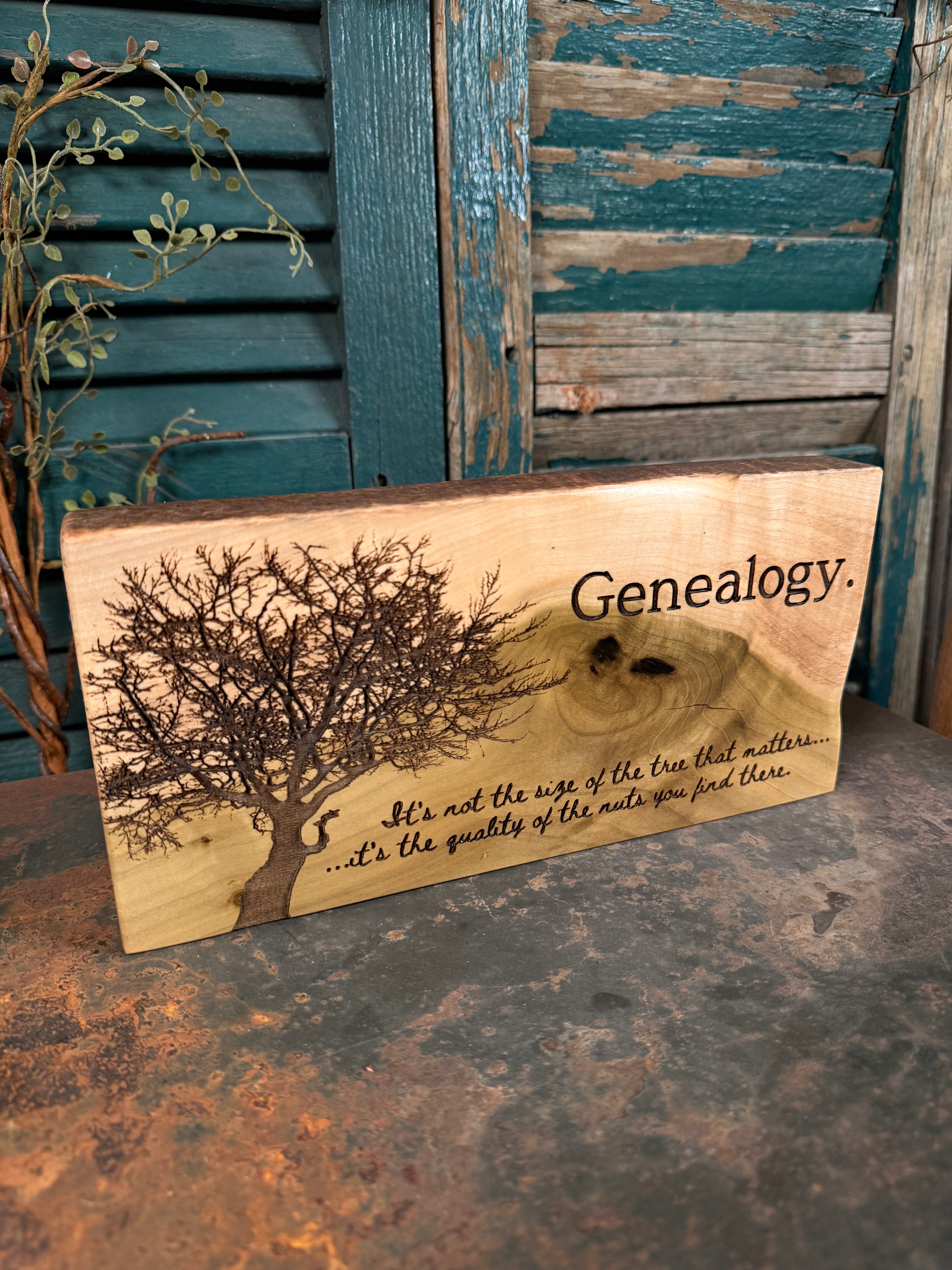 Wooden plaque with genealogy design and text on a rustic surface.