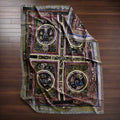 Decorative blanket with intricate patterns on a light gray background